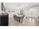 Bright dining room featuring a long wood table, seating for ten, and a decorative display cabinet at 1120 43Rd N Ave, St Petersburg, FL 33703