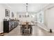 Well lit dining room features a large dark wood table, tile floors, and a decorative bar cabinet at 1120 43Rd N Ave, St Petersburg, FL 33703
