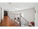 Hallway overlooking the main room, with railing and hardwood floors at 1120 43Rd N Ave, St Petersburg, FL 33703