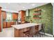 Modern kitchen featuring a subway tile backsplash, stainless steel appliances, and an island with bar seating at 1120 43Rd N Ave, St Petersburg, FL 33703