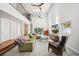 Open-concept living space with high ceilings, large windows, modern decor, and a staircase leading to a second level at 1120 43Rd N Ave, St Petersburg, FL 33703