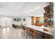 Open-concept living area featuring tile flooring, modern furniture, and seamless flow into the adjacent kitchen at 1120 43Rd N Ave, St Petersburg, FL 33703