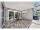 Relaxing covered patio with brick pavers, ceiling fan, and view of the backyard pool at 1120 43Rd N Ave, St Petersburg, FL 33703