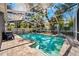 Enclosed pool with screened enclosure, mature landscaping, and brick paver patio for private relaxation at 1120 43Rd N Ave, St Petersburg, FL 33703