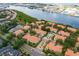 Aerial view of waterfront community featuring tile roofs, mature trees, and marina access at 1122 Shipwatch Cir, Tampa, FL 33602