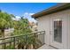 Balcony with metal railing offering lush views of palm trees and surrounding neighborhood at 1122 Shipwatch Cir, Tampa, FL 33602