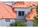 Balcony with metal railing offering views of terra cotta tile roofs and palm trees at 1122 Shipwatch Cir, Tampa, FL 33602