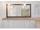 An elegant bathroom featuring dual vanities, a soaking tub, and a glass-enclosed shower with decorative lighting at 1122 Shipwatch Cir, Tampa, FL 33602