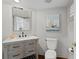 Updated bathroom with a gray vanity, marble countertop, and a sailboat painting at 1122 Shipwatch Cir, Tampa, FL 33602