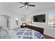 This stylish bedroom boasts a large wall-mounted television, bright walls, and plantation shutters at 1122 Shipwatch Cir, Tampa, FL 33602