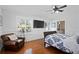 This stylish bedroom boasts a large wall-mounted television, a leather chair, and plantation shutters at 1122 Shipwatch Cir, Tampa, FL 33602