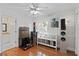 Bedroom featuring hardwood floors, a ceiling fan, and music listening station with speakers, amps, and vinyl records at 1122 Shipwatch Cir, Tampa, FL 33602