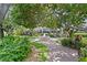 Landscaped courtyard featuring a fountain, lush trees, and brick pathways creating a serene community gathering space at 1122 Shipwatch Cir, Tampa, FL 33602