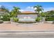 Well-maintained entrance featuring a fountain, lush landscaping, and an iron gate to the community at 1122 Shipwatch Cir, Tampa, FL 33602
