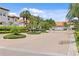 Community entrance showcasing lush landscaping, mature palm trees, and meticulous grounds providing an elegant welcome at 1122 Shipwatch Cir, Tampa, FL 33602
