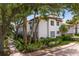 Beautiful two-story home exterior with lush landscaping, brick walkway, and private outdoor patio at 1122 Shipwatch Cir, Tampa, FL 33602