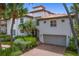 Stunning two-story home with a red tile roof, lush landscaping, and a two-car garage at 1122 Shipwatch Cir, Tampa, FL 33602