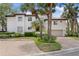 Beautiful two-story house with lush landscaping, a red tile roof, and a brick paver driveway at 1122 Shipwatch Cir, Tampa, FL 33602