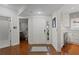Inviting foyer with hardwood floors, a view of the bathroom, and entry to the kitchen at 1122 Shipwatch Cir, Tampa, FL 33602