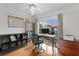 Bright home office featuring a ceiling fan, built-in shelving, and a large window with neighborhood views at 1122 Shipwatch Cir, Tampa, FL 33602