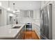 Contemporary kitchen with island, stainless steel appliances, white cabinets, and hardwood floors at 1122 Shipwatch Cir, Tampa, FL 33602