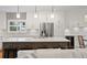 Open floor plan with stainless steel appliances, bar fridge, white cabinets, and a kitchen island with seating at 1122 Shipwatch Cir, Tampa, FL 33602
