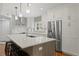 Bright kitchen featuring an island, white cabinets, stainless steel appliances, and modern pendant lighting at 1122 Shipwatch Cir, Tampa, FL 33602