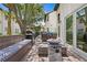 Enjoy this inviting patio area featuring a grill, fire pit, built-in bench, and dining set at 1122 Shipwatch Cir, Tampa, FL 33602