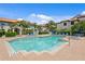 Community pool featuring clear blue water, lounge chairs, and umbrellas, surrounded by meticulously maintained landscaping at 1122 Shipwatch Cir, Tampa, FL 33602