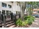 Back deck with steps leading down to a landscaped yard with beautiful trees at 1122 Shipwatch Cir, Tampa, FL 33602