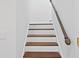 Staircase with wooden steps and decorative metal railing at 1122 Shipwatch Cir, Tampa, FL 33602