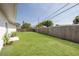 Large grassy backyard with a tall wooden fence offering privacy at 11296 115Th St, Largo, FL 33778