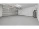 Spacious garage with epoxy floors, a garage door, and white walls at 11296 115Th St, Largo, FL 33778