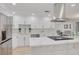 Gourmet kitchen featuring white cabinets, marble countertops, stainless steel appliances and a modern island at 11296 115Th St, Largo, FL 33778