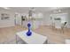 Open-concept living area with a stylish white kitchen featuring a marble island, modern appliances, and sleek fixtures at 11296 115Th St, Largo, FL 33778