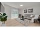 Bright living room featuring modern gray sofa, plush rug, and ample natural light through sliding glass door at 11296 115Th St, Largo, FL 33778