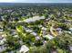 Real estate aerial view of a home near a tranquil lake and golf course in a quiet neighborhood at 1235 Nelson St, Dunedin, FL 34698