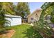 Well-maintained backyard features a shed and lush landscaping, offering privacy at 1235 Nelson St, Dunedin, FL 34698