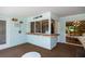 A cute bar area in an enclosed lanai features a pass through window for snacks and refreshments at 1235 Nelson St, Dunedin, FL 34698