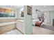 Bathroom and Bedroom featuring a tub, vanity, and bedroom with access to a patio and pool at 1235 Nelson St, Dunedin, FL 34698