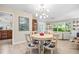 Elegant dining area featuring modern lighting and seamlessly connected to the inviting living room space at 1235 Nelson St, Dunedin, FL 34698