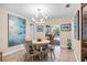 Bright dining room features a modern light fixture and views of the outdoor pool area at 1235 Nelson St, Dunedin, FL 34698