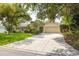 Inviting home featuring a spacious driveway, manicured landscaping, and a charming exterior at 1235 Nelson St, Dunedin, FL 34698