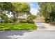 Charming single-story home features a well-manicured lawn, mature trees, and a two-car garage at 1235 Nelson St, Dunedin, FL 34698