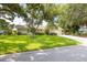 Charming single-story home with a well-manicured lawn, mature trees, and a serene neighborhood setting at 1235 Nelson St, Dunedin, FL 34698