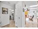 Hallway leading to the living room and laundry room, featuring tile floors, and natural light at 1235 Nelson St, Dunedin, FL 34698