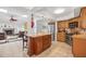 Open concept kitchen featuring a central island, stainless steel appliances, and tile flooring at 1235 Nelson St, Dunedin, FL 34698