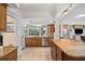 A bright kitchen with stainless steel appliances, stone countertops, and a view to the outdoors at 1235 Nelson St, Dunedin, FL 34698