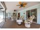 Covered lanai offers comfortable seating, ceiling fans, and a view of the sparkling pool at 1235 Nelson St, Dunedin, FL 34698