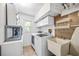 Bright laundry room offers tile floors, modern washer and dryer, and lots of storage at 1235 Nelson St, Dunedin, FL 34698